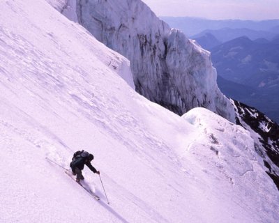 Cyril Benda skis by an ice cliff.